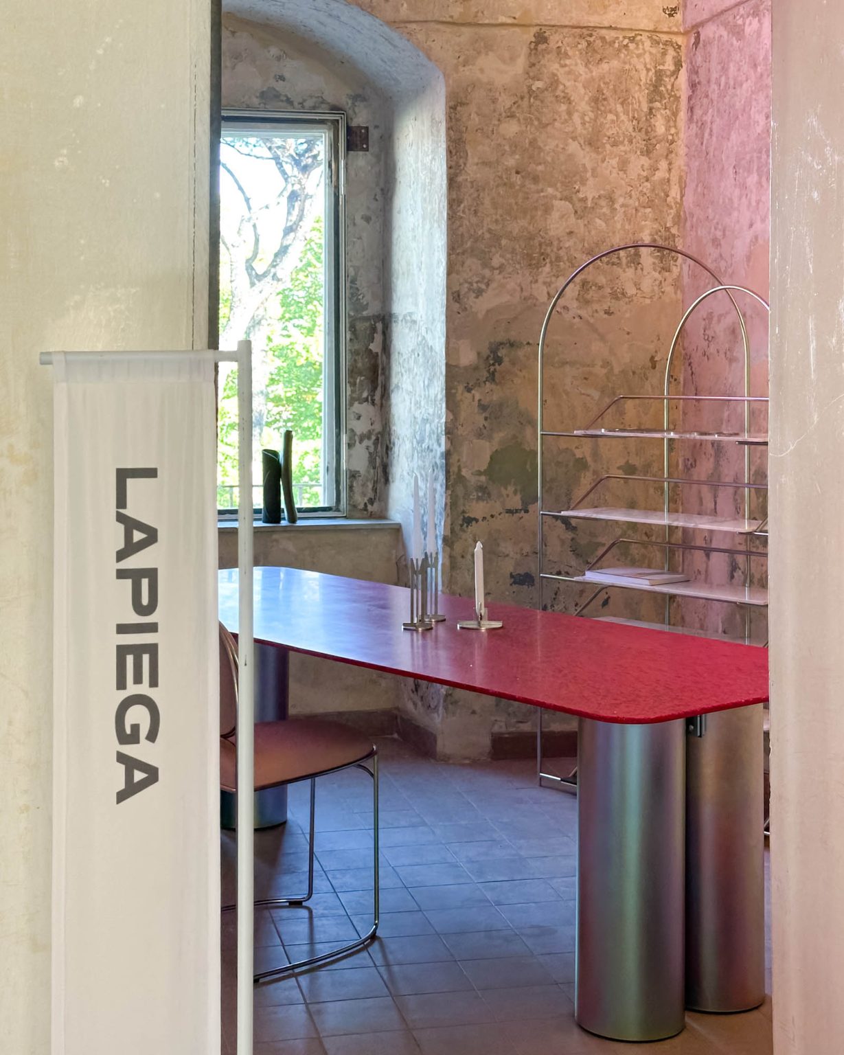 lapiegaWD booth at the Santissima during EDIT Napoli 2025, featuring metal pieces in Rainbow finish and natural light reflections.